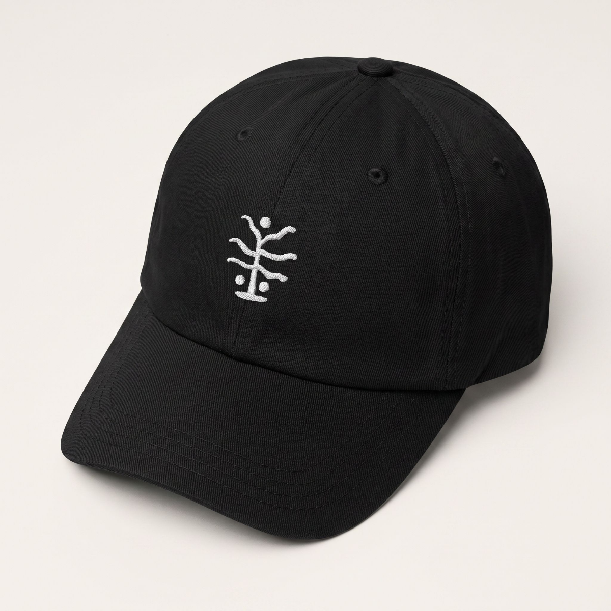 Seaweed embroidered black six-panel cap, three-quarter front view on a white background