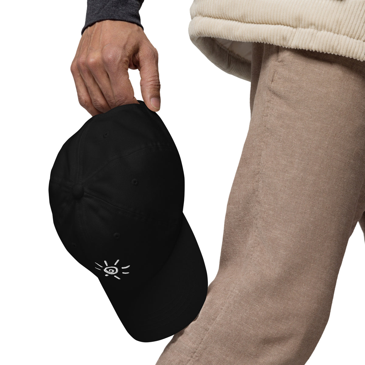 Sun icon embroidered black dad cap held in hand, left side view