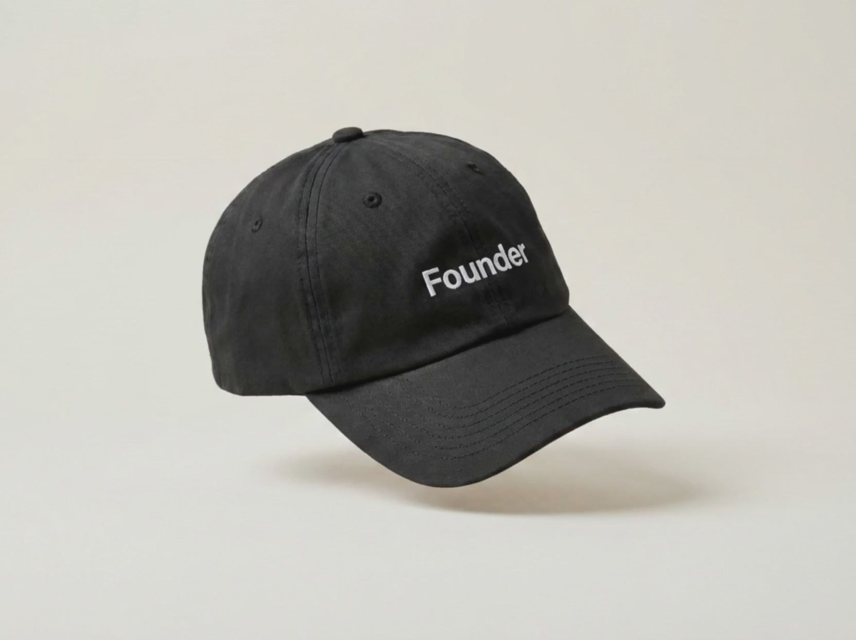 Video: the Founder black cap turning slowly in profile on a cream studio backdrop