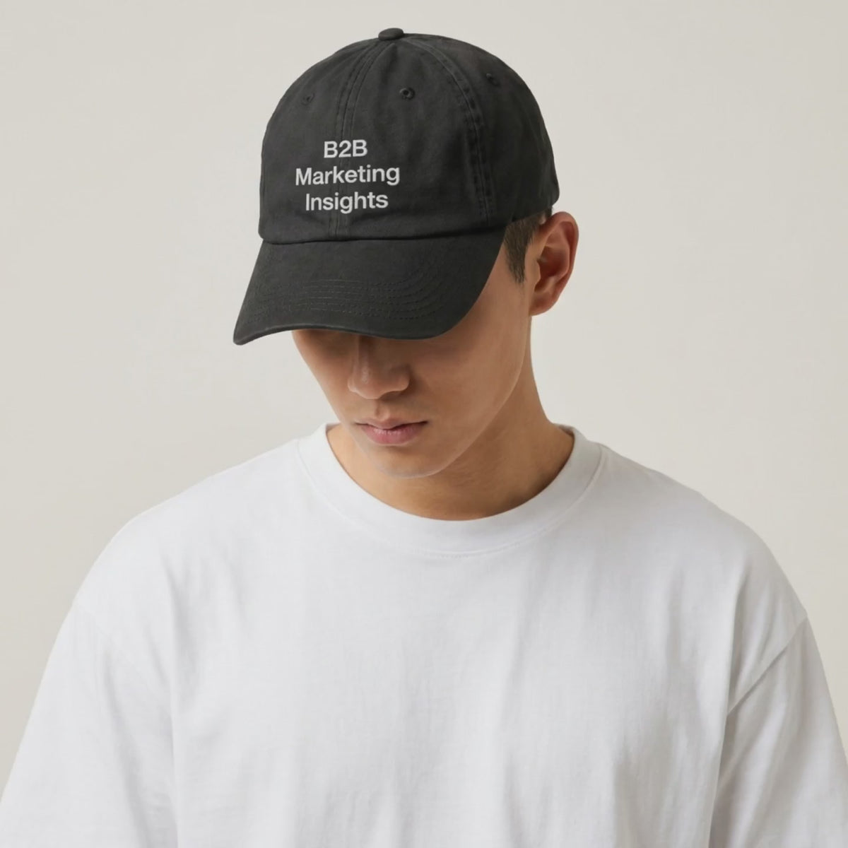 Video: model in a white tee wearing the B2B Marketing Insights black cap