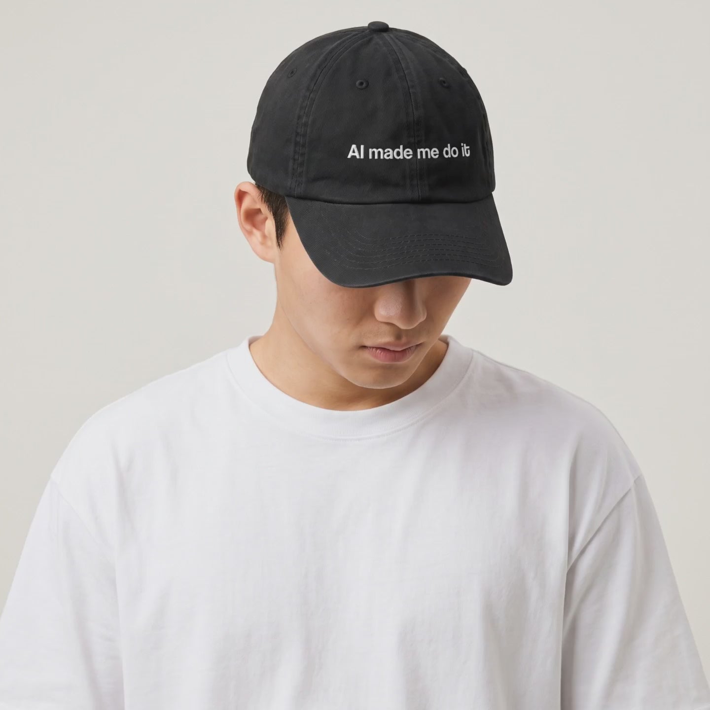 Video: close-up of the AI Made Me Do It cap, then a model in a white tee wearing it